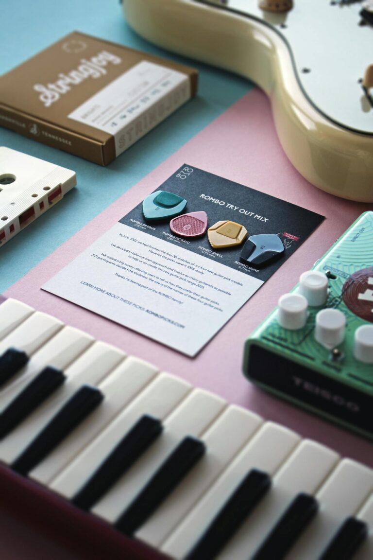 Colorful music setup with guitar picks, petals, and keyboard. Ideal for creative stock use.